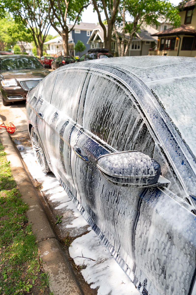 Four Seasons Detailing team cleaning a blue BMW in St Paul street